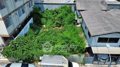 Vacant land plot surrounded by residential buildings, ideal for development opportunities.