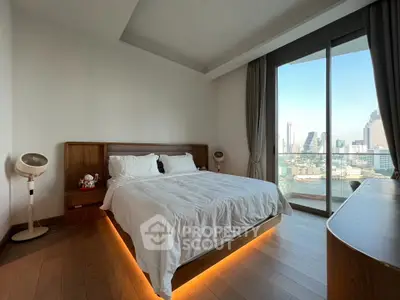 Luxurious bedroom with city view and modern decor in high-rise apartment
