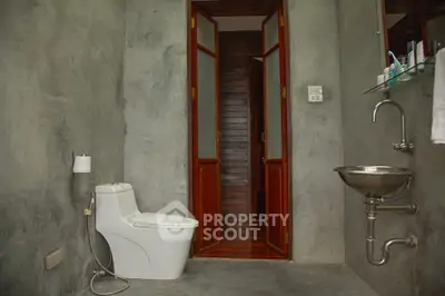 Modern minimalist bathroom with concrete walls and sleek fixtures