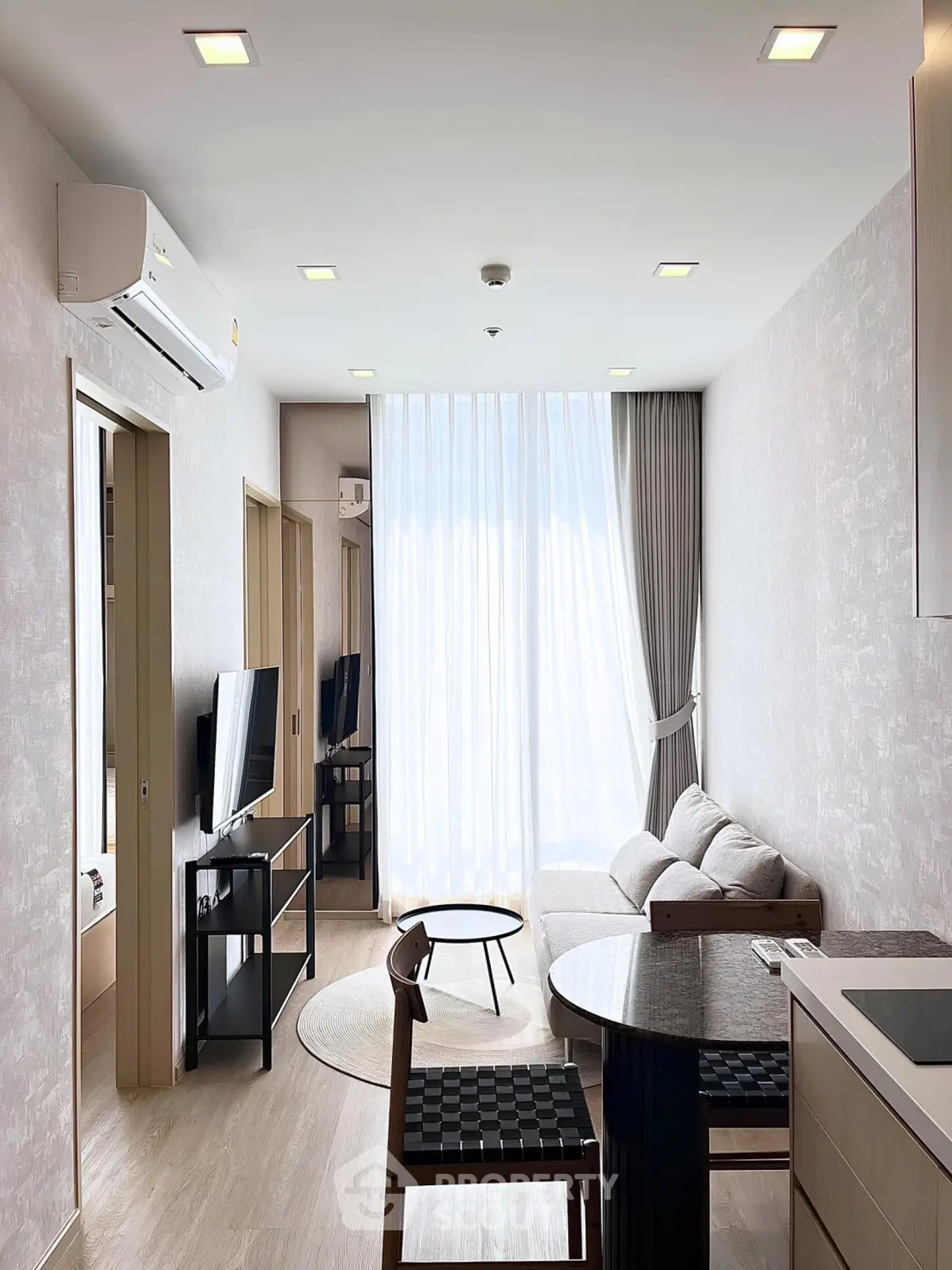 Modern living room with sleek furniture and natural light in a stylish apartment.