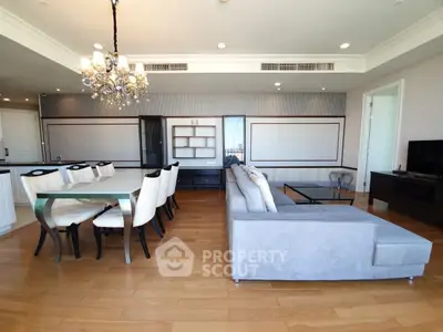 Spacious modern living room with elegant dining area and luxurious chandelier