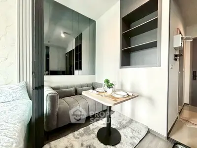 Modern compact living room with cozy sofa and dining table in stylish apartment