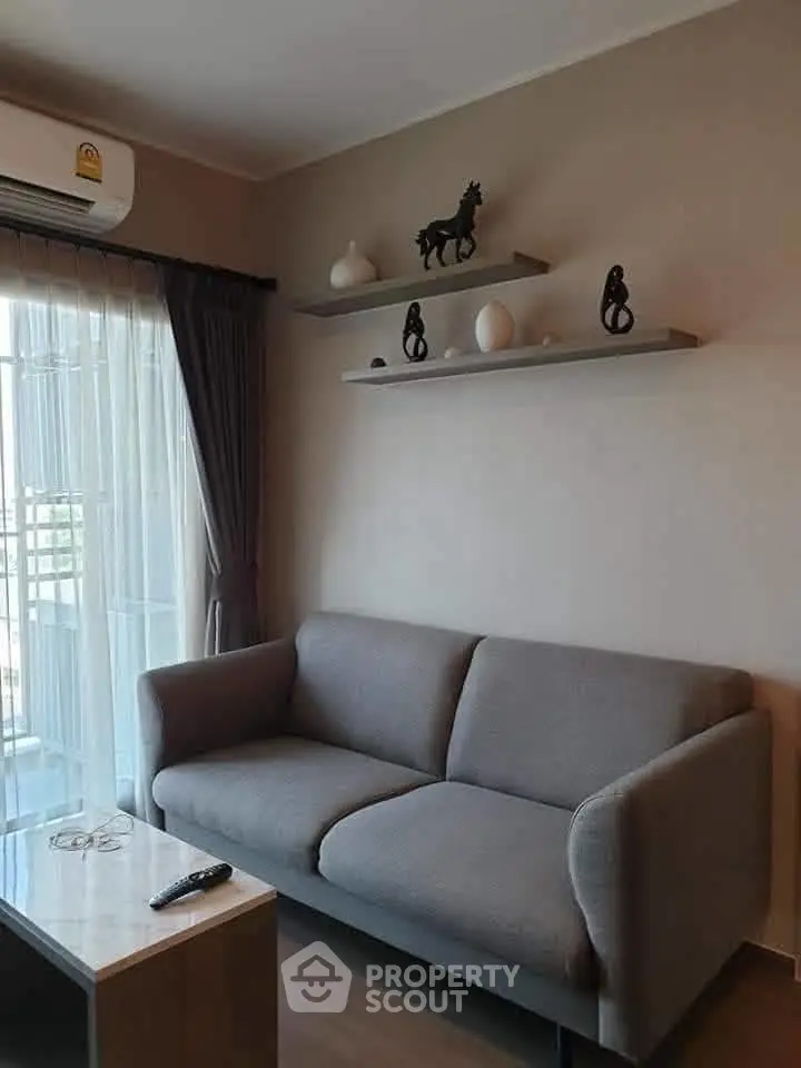 Modern living room with sleek gray sofa and decorative shelves, perfect for stylish urban living.
