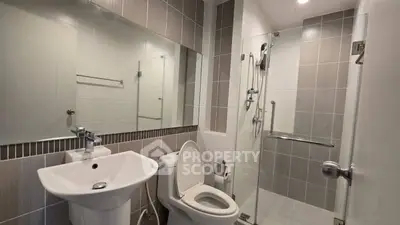 Modern bathroom with sleek fixtures and glass shower enclosure