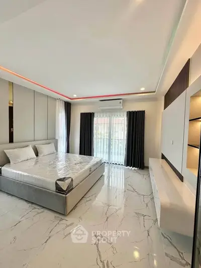 Luxurious modern bedroom with marble flooring and large windows for natural light.