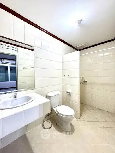 Spacious bathroom with modern fixtures and elegant tile design, perfect for a relaxing retreat.