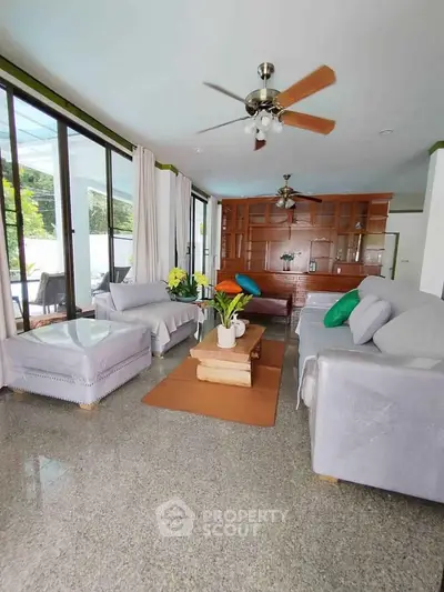 Spacious living room with modern decor and large windows for natural light.