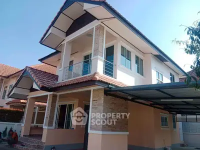 Modern two-story house with tiled roof and spacious carport
