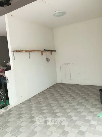 Spacious tiled storage area with wall-mounted shelves and clean design