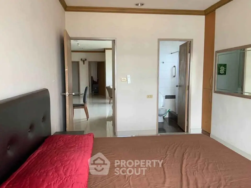 Spacious bedroom with ensuite bathroom in modern apartment