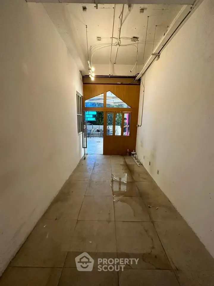 Spacious entryway with tiled flooring leading to outdoor patio area.
