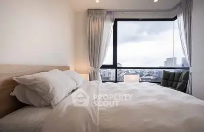 Modern bedroom with large window offering stunning city view