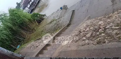 Riverside property with stone steps leading to the water, ideal for serene living.