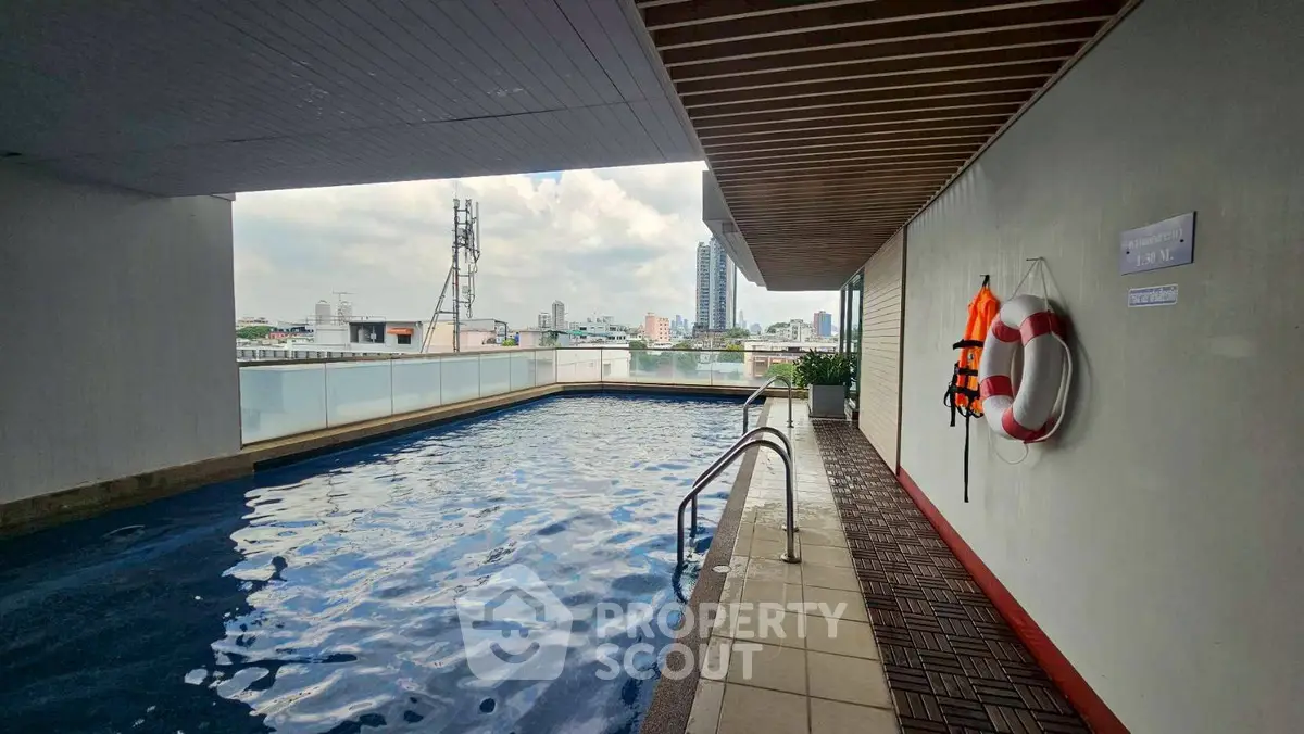Luxurious rooftop pool with city skyline view, perfect for relaxation and leisure.