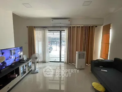Spacious living room with modern decor and large windows for natural light.
