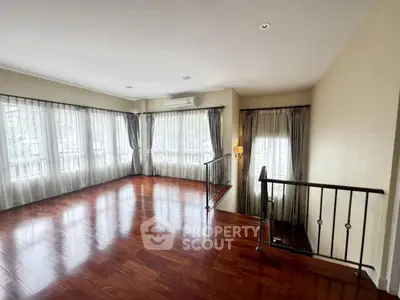 Spacious corner unit with elegant wooden flooring and abundant natural light
