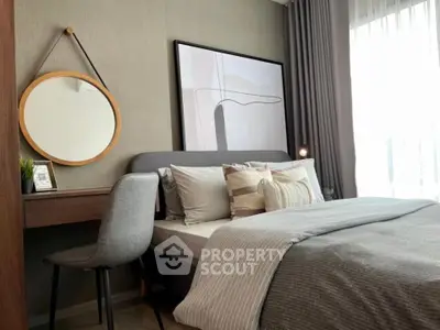 Modern bedroom with stylish decor, featuring a cozy bed, elegant artwork, and natural light from large windows.