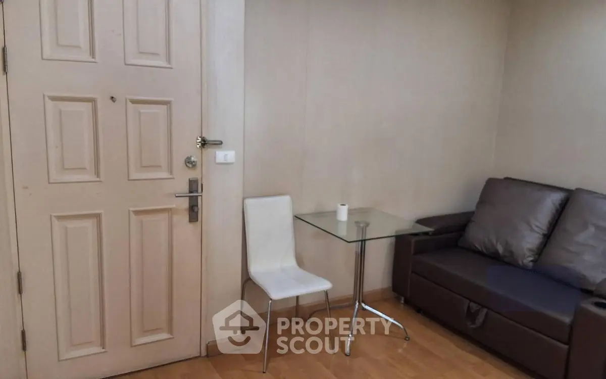 Cozy living room corner with modern sofa and glass table