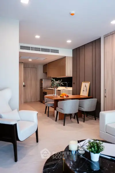 Modern open-plan living room with stylish furniture and dining area in a contemporary apartment.
