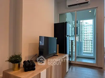 Modern living room with TV and balcony view in high-rise apartment