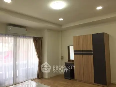 Spacious bedroom with modern wardrobe and natural light