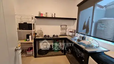 Modern kitchen with gas stove and sleek design, featuring ample counter space and natural light.