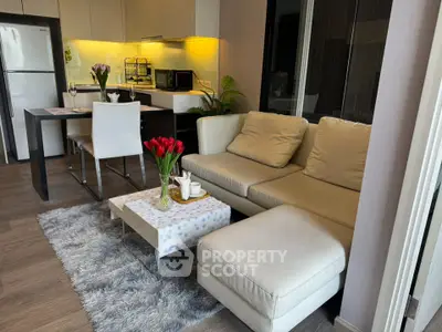 Modern living room with cozy sofa and stylish kitchen area