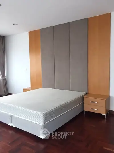Spacious bedroom with modern design and hardwood flooring