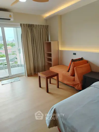 Spacious bedroom with balcony access and modern furnishings