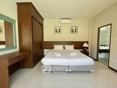 Spacious bedroom with elegant wooden furniture and modern decor