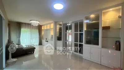 Spacious living room with elegant built-in cabinets and modern lighting