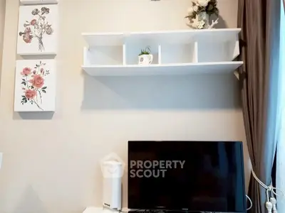 Modern living room with wall-mounted TV and decorative shelving.