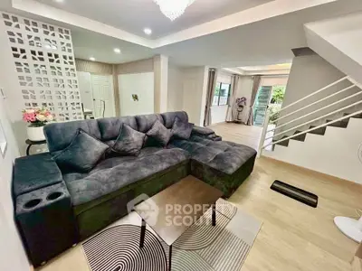 Spacious modern living room with plush sofa and stylish decor in a contemporary home.