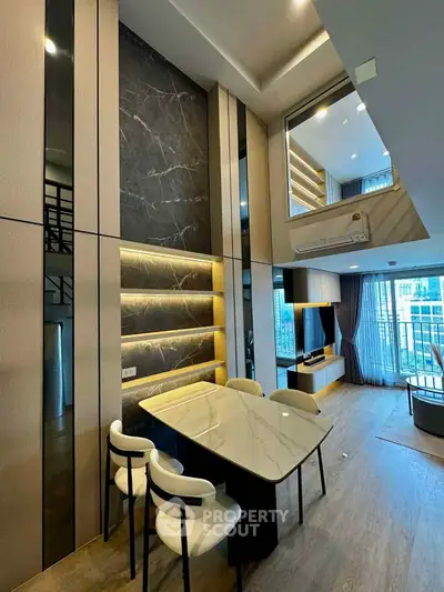 Luxurious modern living room with high ceilings and elegant decor in a stylish apartment.