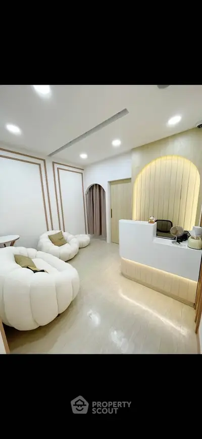 Modern interior with plush seating and sleek reception desk in a stylish office or lounge area.