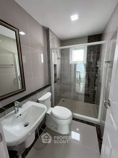 Modern bathroom with sleek fixtures and glass shower enclosure