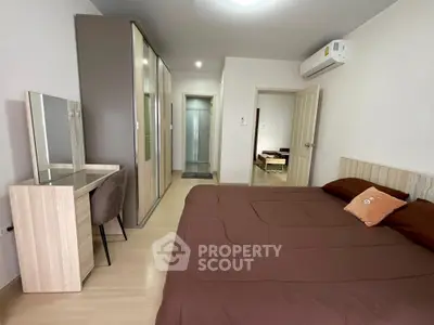 Spacious bedroom with modern furniture and ample closet space