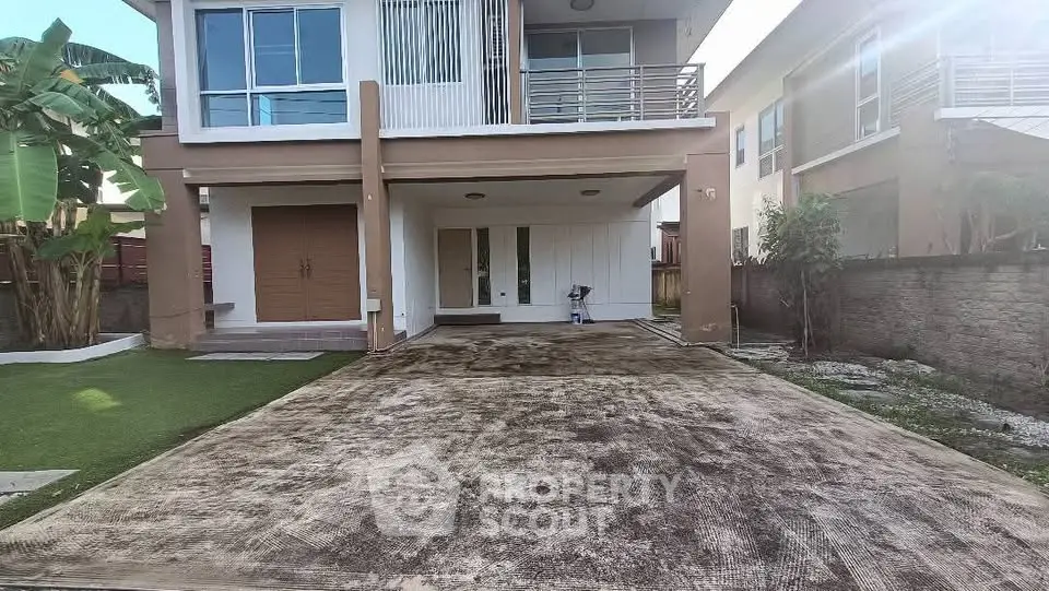 Modern two-story house with spacious driveway and balcony