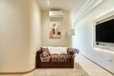 Modern living room with cozy sofa, wall-mounted TV, and stylish decor