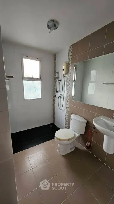 Modern bathroom with sleek tiles and natural light from window