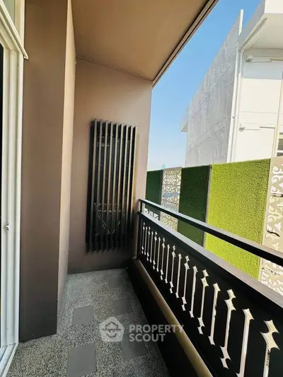 Chic modern balcony with stylish railing and privacy screen, perfect for relaxation.