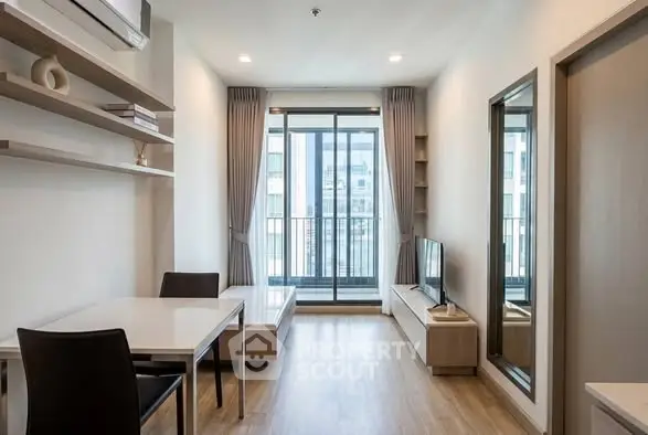 Modern living room with balcony view, sleek furniture, and natural light.