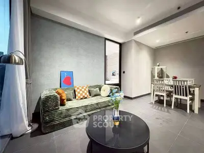 Modern living room with stylish decor and dining area, featuring cozy seating and elegant lighting.