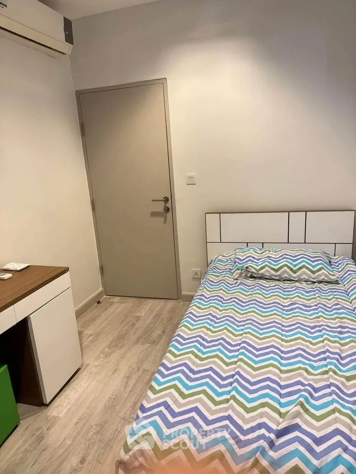 Cozy bedroom with modern decor and air conditioning, perfect for comfortable living.