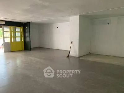 Spacious empty room with tiled flooring and large windows, ideal for customization.