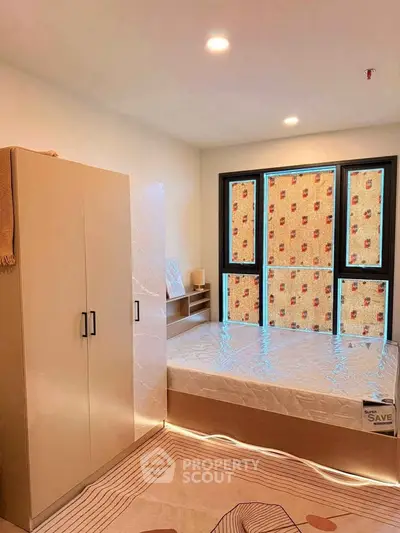 Modern bedroom with large windows and stylish furniture