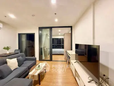 Modern living room with sleek furniture and open view to bedroom, perfect for urban living.