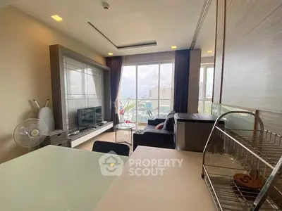 Modern living room with large windows and city view, featuring stylish furniture and open layout.