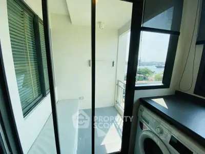 Modern apartment balcony with washing machine and scenic view