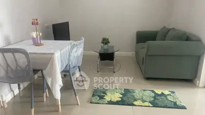 Cozy living room with modern furniture and dining area, perfect for small gatherings.